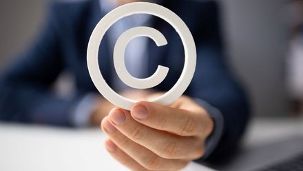 Image of person holding copyright symbol