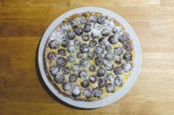Cherry clafoutis sprinkled with icing sugar