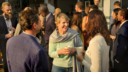 A group of people of different ages and sexes talking 