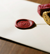 Close up image of a red seal on a white envelope 