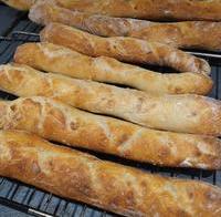 A pile of sourdough baguettes