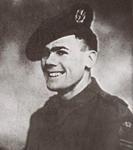 Black and white image of a man looking to the left of the camera. He is wearing an army uniform and beret 