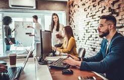 A modern office environment with several people working