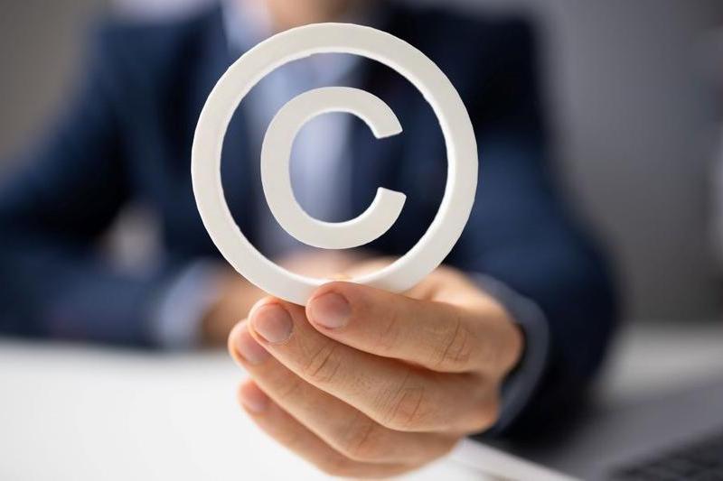 Image of person holding copyright symbol